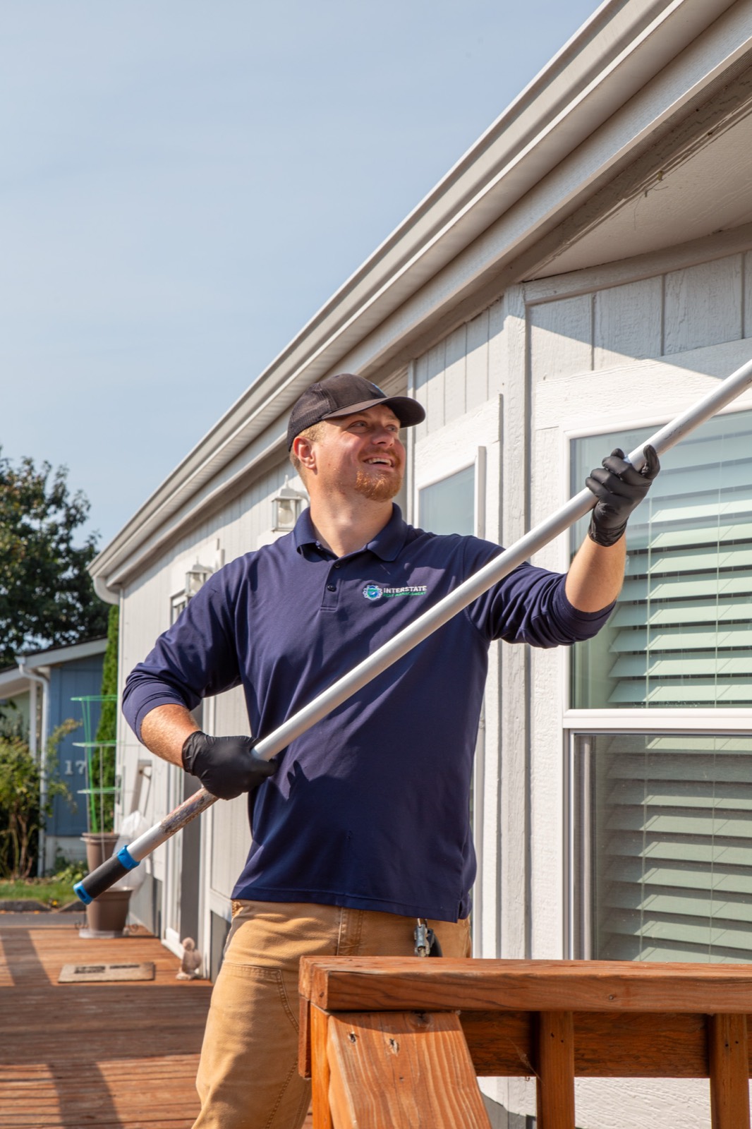 Interstate Pest Management technician treating a home